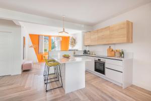 a kitchen with white cabinets and a counter top at Esperance - Brand New luxury studio with parking in Bowness-on-Windermere