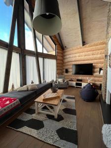 a living room with a couch and a tv at Chalet Donky in Donovaly