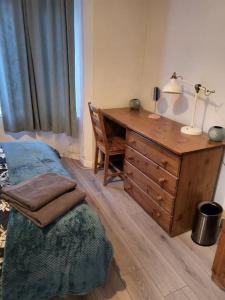 a bedroom with a desk and a bed with a lamp at Entire Flat city centre based. in Parkside