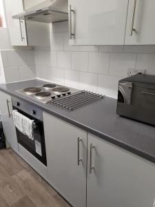 a kitchen with a stove and a counter top at Entire Flat city centre based. in Parkside