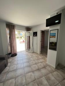 a living room with a tiled floor and a door at San Agustin apartments , close to the BEACH, with pool! in San Bartolomé