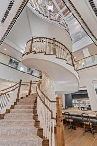 a spiral staircase in a building with a stair case at The Shepherd Hotel Downtown Clemson in Clemson