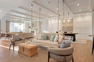 a living room with a couch and chairs at The Shepherd Hotel Downtown Clemson in Clemson