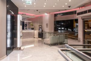 a lobby with a chair and a table in a building at SANA Capitol Hotel in Lisbon