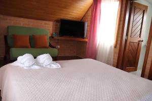 Ένα ή περισσότερα κρεβάτια σε δωμάτιο στο La Gran Estancia Hotel Campestre