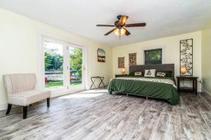 a bedroom with a bed and a ceiling fan at Chelsea Lake House, Game Room, & Pontoon-rental in Chelsea