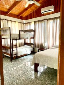 a bedroom with two bunk beds and a ceiling at Tranquilidad Resort in Parrita