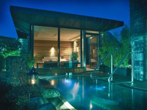a house with a swimming pool at night at Castlecourt Hotel, Spa & Leisure in Westport