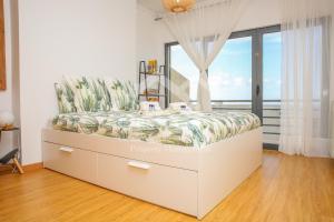 a bed in a room with a window at Casa Menezes in Lourinhã +68 photos
