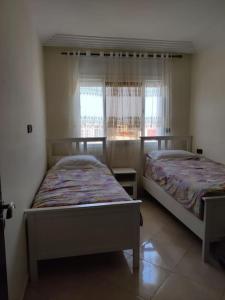 Ένα ή περισσότερα κρεβάτια σε δωμάτιο στο Appartement proche de Rabat et de l'aéroport