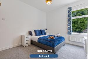 a bedroom with a bed and a window at Stoke On Trent - 2 Bedroom Sleeps 5, Wi-Fi, Garden - JRR Stays in Etruria