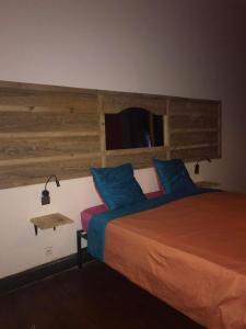 a bedroom with a bed with blue and orange sheets at La Casa Blu in Antananarivo