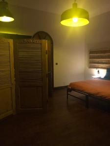 a bedroom with a bed and a yellow light at La Casa Blu in Antananarivo