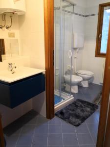 a bathroom with a shower and a sink and a toilet at Chalet Luna in Caspoggio