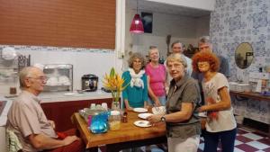 a group of people standing around a table in a kitchen at Homestay Chez Moi in Can Tho