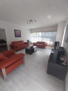 a large living room with couches and tables at Vaal holiday home in Vanderbijlpark