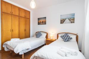 A bed or beds in a room at ES GANXO HOUSE PORTO CRISTO