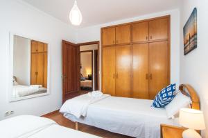 A bed or beds in a room at ES GANXO HOUSE PORTO CRISTO