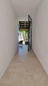 an empty hallway with a staircase in a white room at Departamento de huéspedes con piscina y parrilla, Tranquilo y Céntrico in Colonia del Sacramento