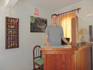 a man standing at a bar in a room at Hotel La Casona in La Paloma