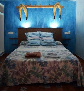 a bedroom with a bed with two bags on it at Casa Rural El Pajar de Puchero in Ruidera