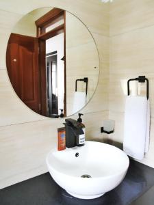 a bathroom with a white sink and a mirror at Zendo Suite in Nairobi