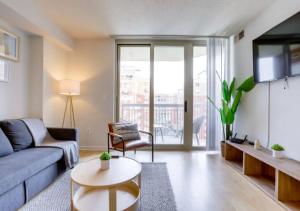 a living room with a couch and a table at Fantastic 1BD Condo At Ballston With Gym in Arlington