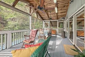 a screened porch with rocking chairs and a ceiling fan at Hannahs Perch on Lake Burton with Private Top Patio and Bottom Dock in Clayton