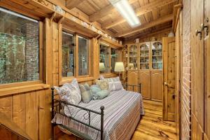 a bedroom with a bed in a room with wooden walls at Hannahs Perch on Lake Burton with Private Top Patio and Bottom Dock in Clayton