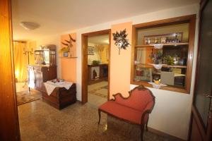 a living room with a red chair and a window at Casa Mary in Lucca