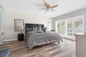 a bedroom with a bed and a ceiling fan at Casa Flamingo Intracoastal Front with Heated Pool a and 75 ft Dock in Fort Lauderdale