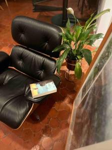 two black leather chairs with a book sitting on them at Atelier 84 - AC - Loft - Avignon Centre Ville in Avignon