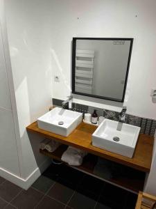 a bathroom with two white sinks and a mirror at Atelier 84 - AC - Loft - Avignon Centre Ville in Avignon