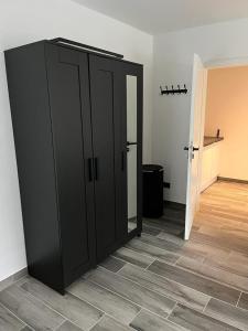 a large black door in a room with a hallway at Haus Gabor in Mülheim an der Ruhr