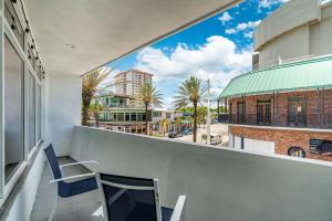 a balcony with a chair and a view of a street at The Purple Pelican Beachfront with Ocean Balcony Unit 4 in Fort Lauderdale