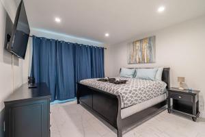 a bedroom with a bed and a flat screen tv at The Purple Pelican Beachfront with Ocean Balcony Unit 4 in Fort Lauderdale