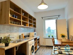 a kitchen with a sink and a dishwasher at Beige Room in Gdańsk