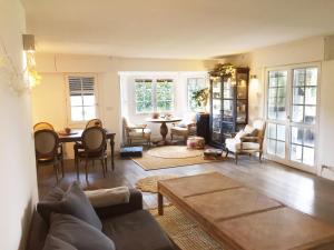 a living room with a couch and a table and chairs at Getxo Garden Houses - Grand Chalet in Getxo