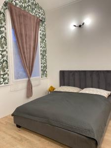 a bedroom with a bed and a window at DMR Apartments in Košice