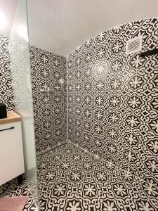 baño con pared estampada en blanco y negro en DMR Apartments, en Košice 5 fotos más