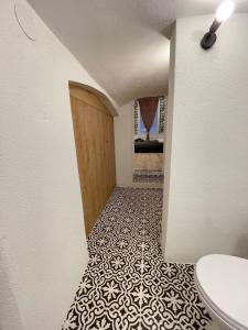 a hallway with a bathroom with a toilet and a door at DMR Apartments in Košice