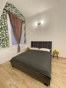 a bedroom with a large bed and a window at DMR Apartments in Košice