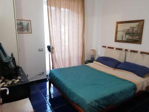 um quarto com uma cama grande e almofadas azuis em Grazioso appartamento a Ischia zona pilastri em Ischia