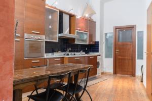 a kitchen with wooden cabinets and a wooden counter top at Milano Brenta Suites Room for 2 in Milan