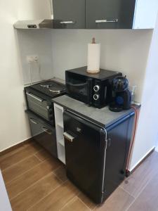 a small kitchen with a stove and a microwave at Апартамент B9 in Borovets