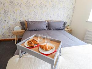 a bed with two plates of bread and glasses of wine at 17 Kings Court in Boston