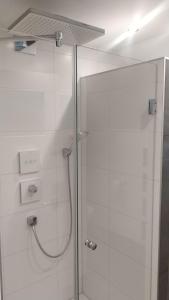 a bathroom with a shower with a glass door at House@Domburg in Domburg