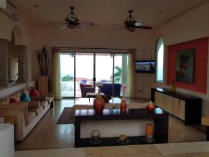 a living room with a couch and a table at Villa Mozzafiato Private Resort with Full Staff and Heated Pool in Puerto Vallarta
