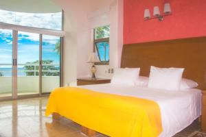 a bedroom with a bed with a yellow and red wall at Villa Mozzafiato Private Resort with Full Staff and Heated Pool in Puerto Vallarta +71 photos