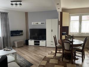 a living room with a table and a television at Tila in Wałcz